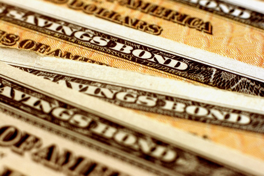 Closeup of EE savings bonds fanned out over one another.