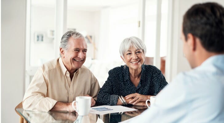 A couple discussing the 401k 55 rule with their advisor.