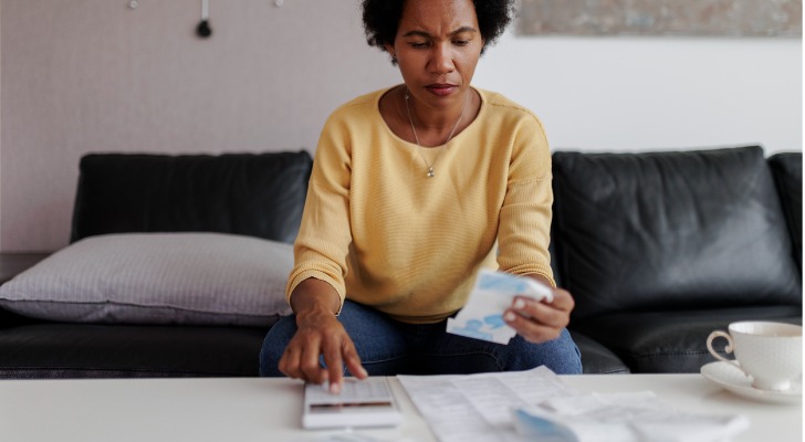 A woman calculating her discretionary expenses