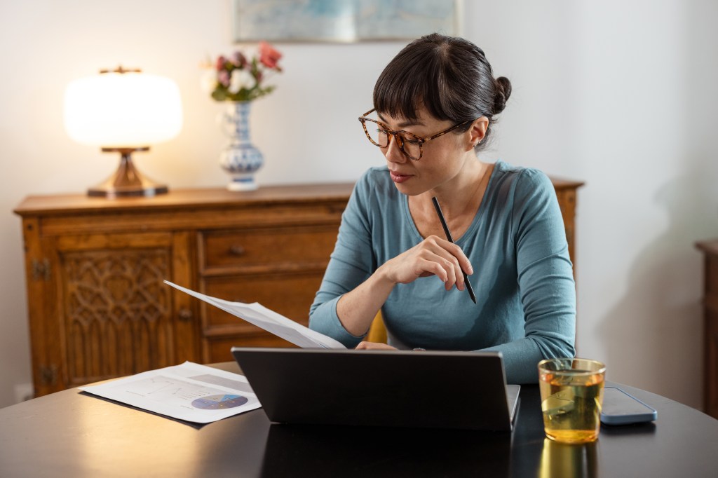 A woman evaluating a real estate investment.