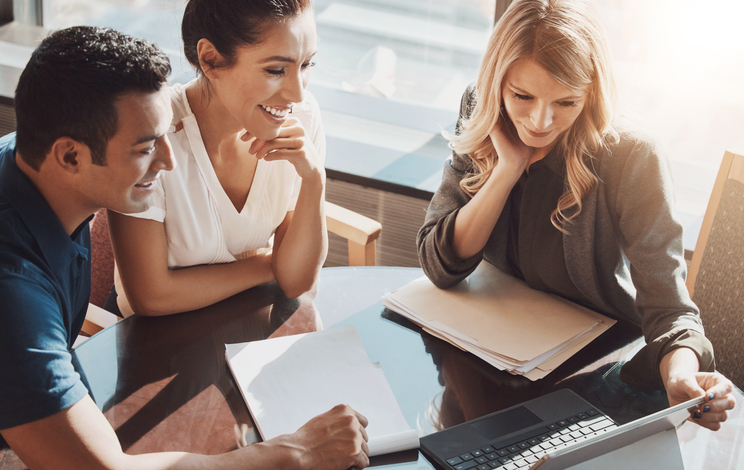 An advisor and their clients reviewing advisor fees.