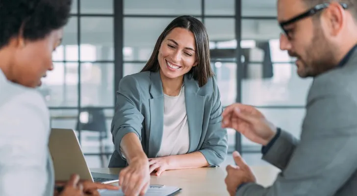 A financial advisor comparing stock investments with a Roth IRA.